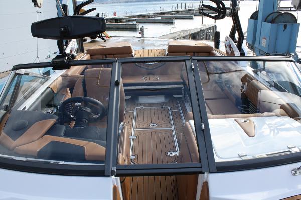 Slide: The Image of 2017 Nautique Super Air G23 boat interior with brown seating and sleek design. - 16