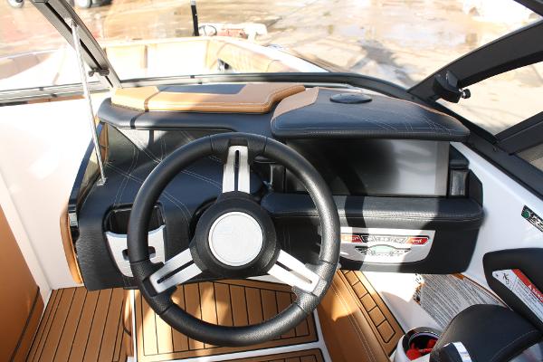 Slide: The Image of 2017 Nautique Super Air G23 boat dashboard with steering wheel and control panel. - 19