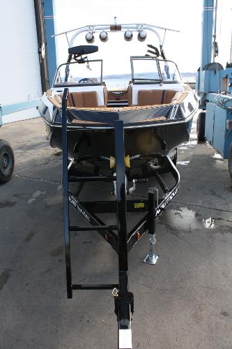Slide: The Image of 2017 Nautique Super Air G23 boat on trailer, dockside view. - 2