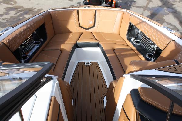 Slide: The Image of 2017 Nautique Super Air G23 boat interior with tan leather seating and cup holders. - 22