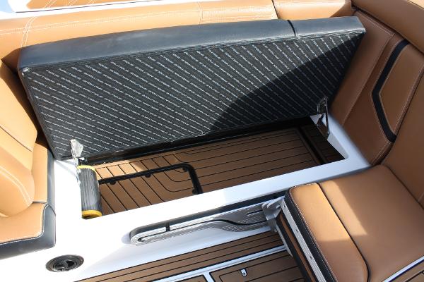 Slide: The Image of 2017 Nautique Super Air G23 interior storage compartment with tan and black seating. - 36