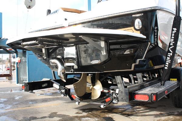 Slide: The Image of 2017 Nautique Super Air G23 boat on trailer, rear view showing propeller and exhaust. - 6
