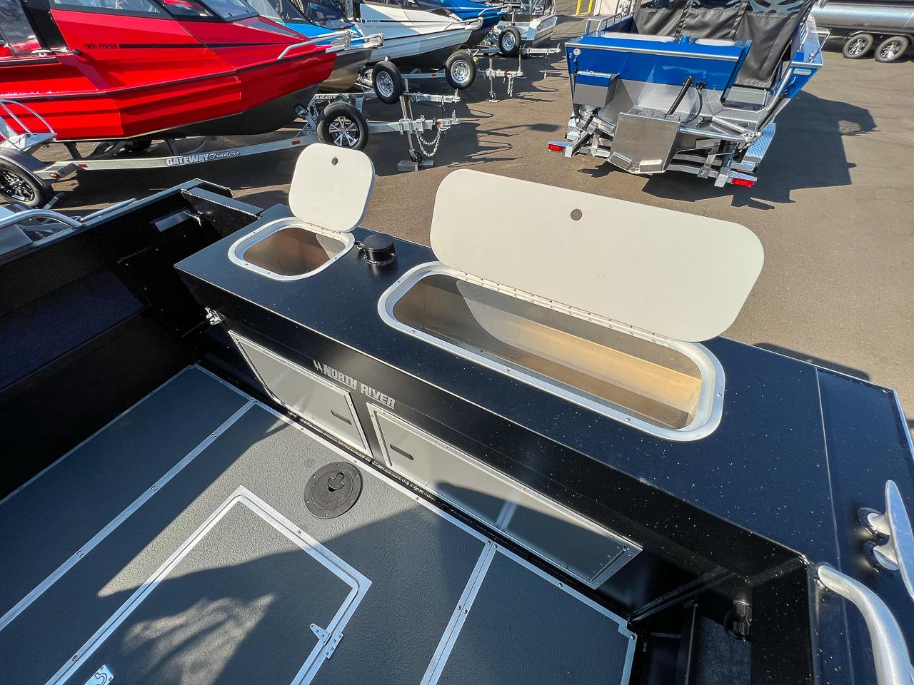 Slide: The Image of 2024 North River 21 SEAHAWK boat interior with storage compartments and other boats in the background. - 20