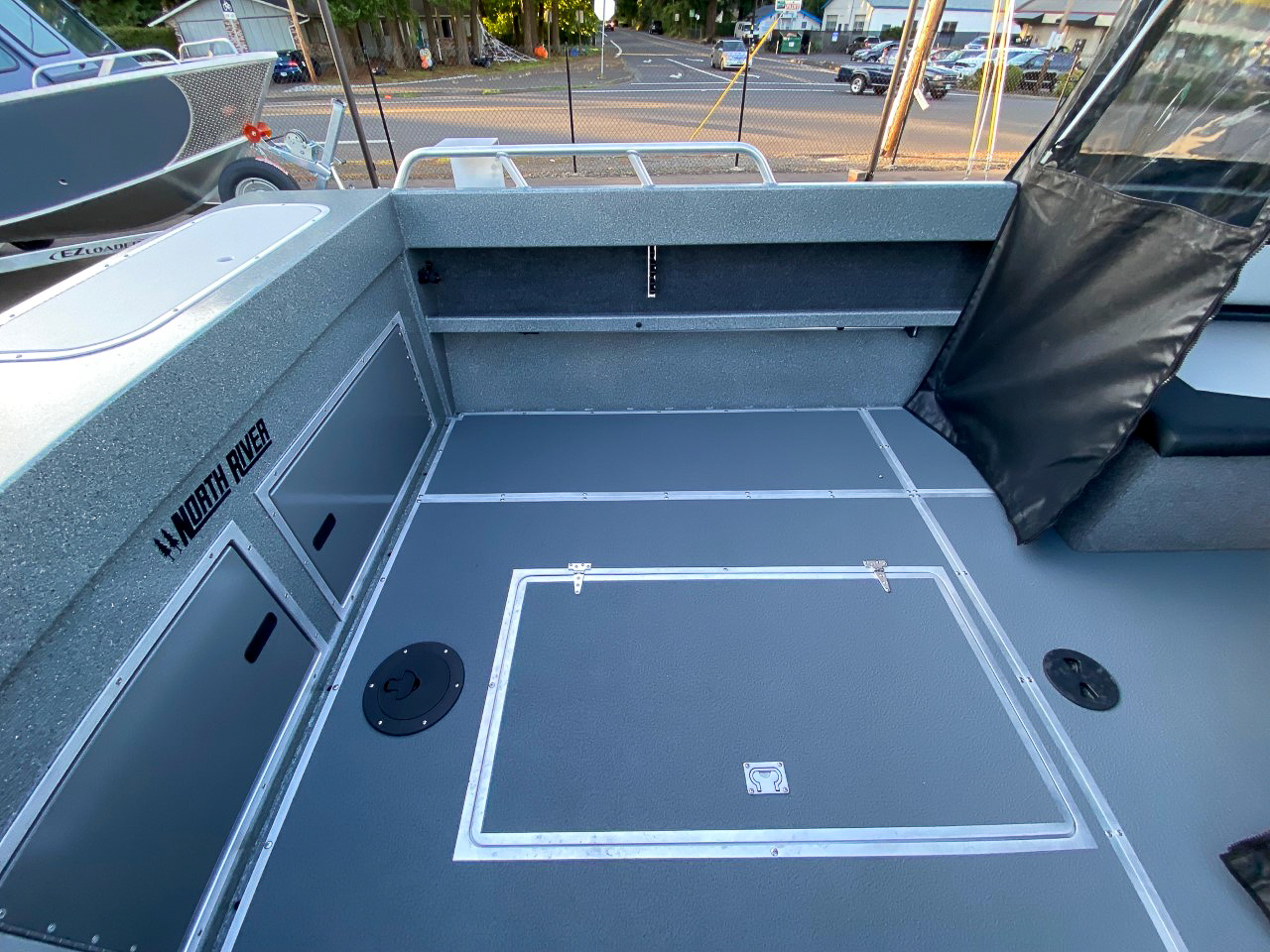 Slide: The Image of 2025 North River 22 Seahawk boat interior, featuring storage compartments and a spacious deck. - 20