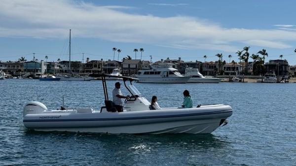 Slide: The Image of 2024 Northstar Orion 8 boat cruising in a marina with passengers. - 9