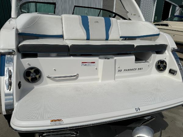 Slide: The Image of 2016 Regal 22 FasDeck ESX boat rear view with seating and speakers. - 13