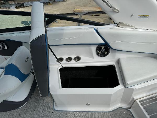 Slide: The Image of 2016 Regal 22 FasDeck ESX boat interior with open storage compartment and seating. - 19