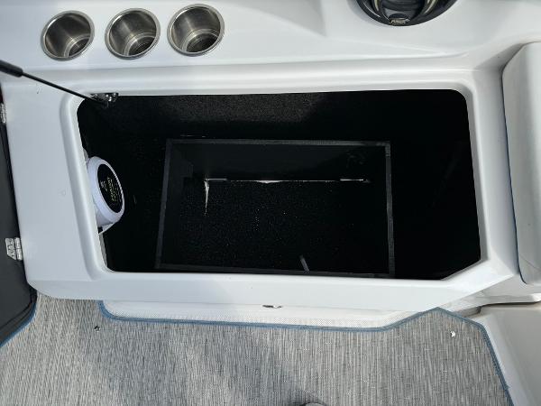 Slide: The Image of 2016 Regal 22 FasDeck ESX boat storage compartment with cup holders. - 20