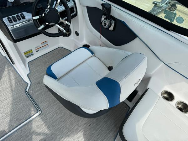 Slide: The Image of 2016 Regal 22 FasDeck ESX boat interior with captain's chair and steering wheel. - 21