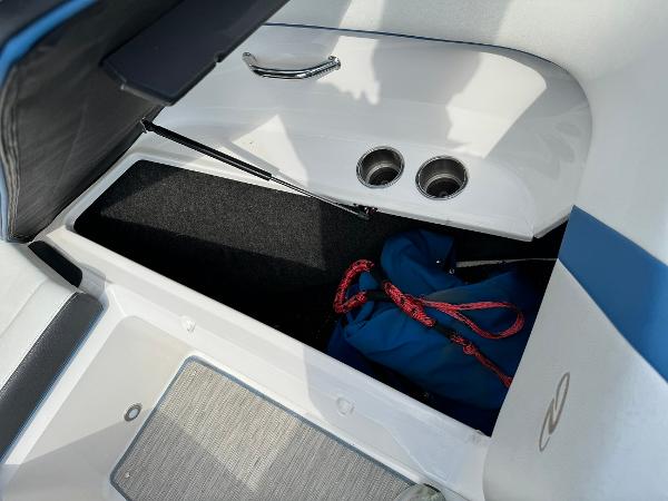Slide: The Image of 2016 Regal 22 FasDeck ESX boat storage compartment with blue bag and red rope. - 29