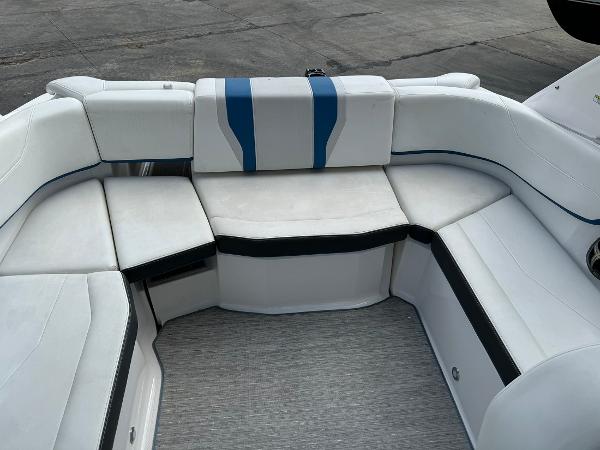 Slide: The Image of 2016 Regal 22 FasDeck ESX boat with white and blue cushioned seating. - 30