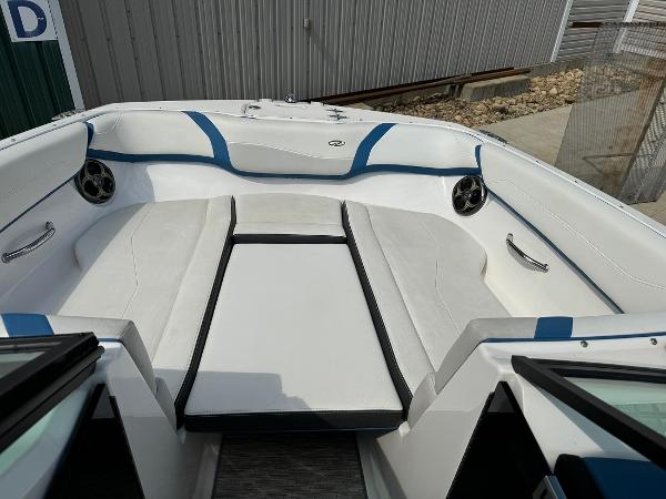 Slide: The Image of 2016 Regal 22 FasDeck ESX boat interior with white and blue seating. - 35