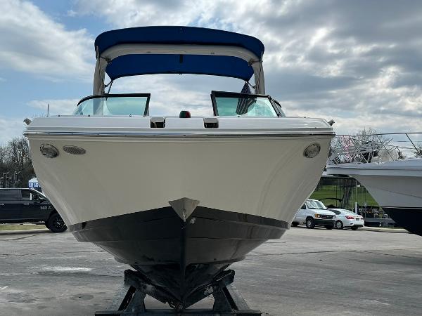 Slide: The Image of 2016 Regal 22 FasDeck ESX boat with blue canopy on a trailer. - 4