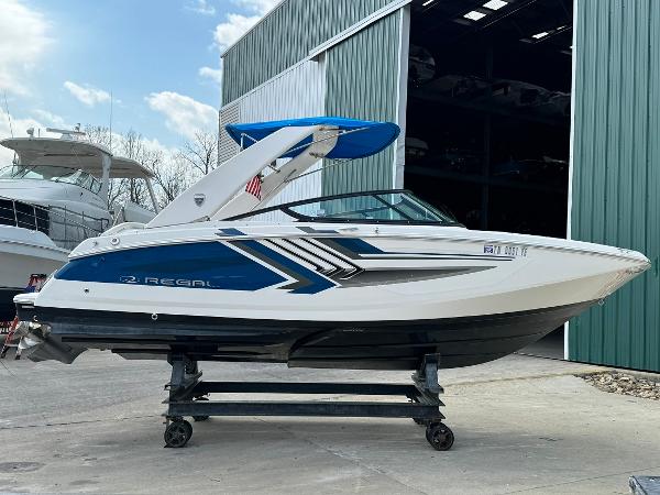 Slide: The Image of 2016 Regal 22 FasDeck ESX boat on a trailer outside a storage facility. - 6