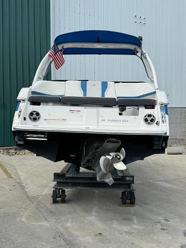 Slide: The Image of 2016 Regal 22 FasDeck ESX boat on a trailer, rear view with American flag. - 8