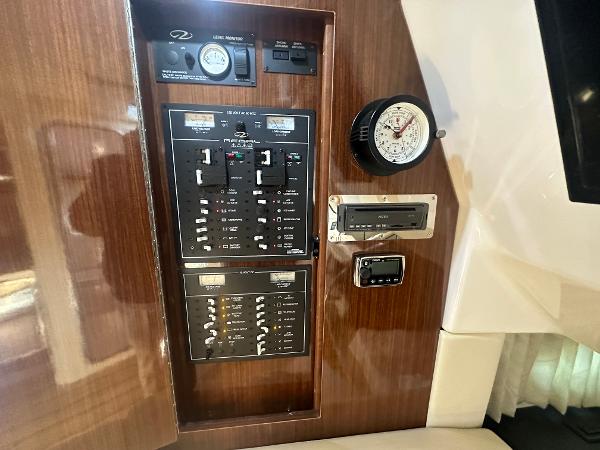 Slide: The Image of Control panel of a 2014 Regal 32 Express boat with gauges and switches. - 19