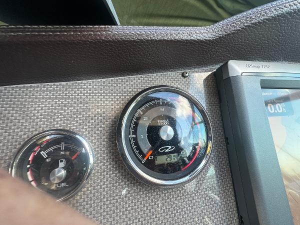 Slide: The Image of Dashboard of a 2014 Regal 32 Express boat with fuel and RPM gauges. - 20