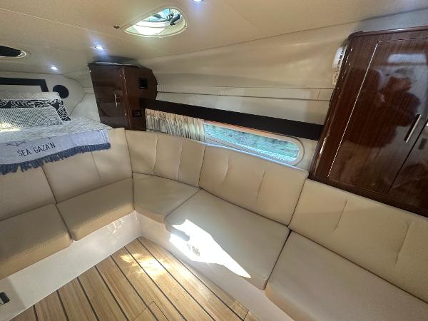 Slide: The Image of 2014 Regal 32 Express cabin interior with beige seating and wood accents. - 4