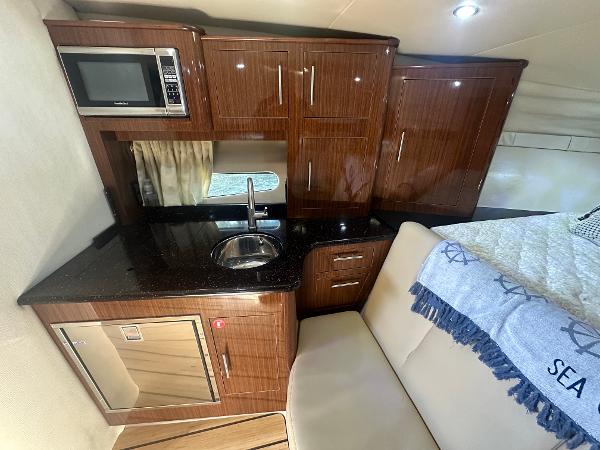 Slide: The Image of Luxurious 2014 Regal 32 Express yacht interior with kitchenette and seating area. - 5