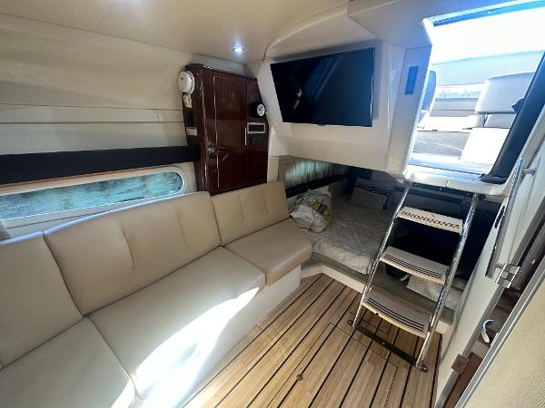 Slide: The Image of Interior of 2014 Regal 32 Express yacht with beige seating and wooden flooring. - 6