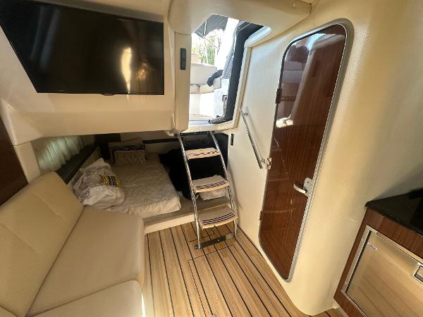 Slide: The Image of Interior of 2014 Regal 32 Express yacht with cozy seating and wooden flooring. - 7