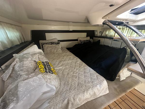Slide: The Image of Interior cabin of 2014 Regal 32 Express boat with cozy bedding. - 9