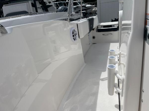Slide: The Image of 2023 Robalo R180 Center Console boat interior with rod holders and seating. - 12