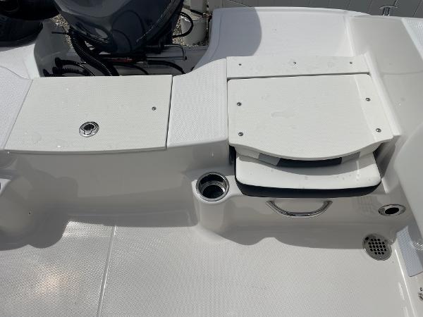 Slide: The Image of 2023 Robalo R180 Center Console boat deck with storage compartments and cup holder. - 18