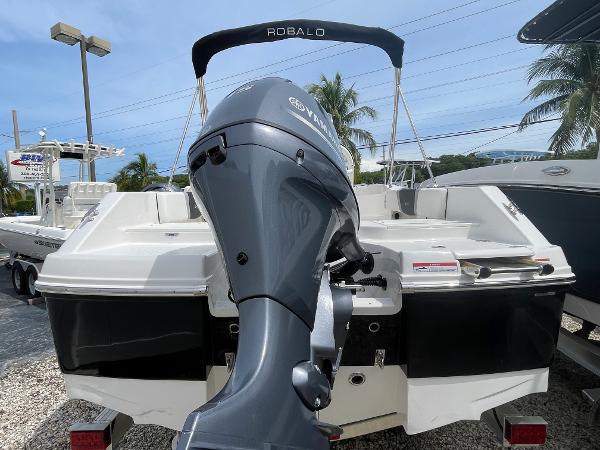 Slide: The Image of 2023 Robalo R180 Center Console boat with Yamaha outboard motor, displayed outdoors. - 2