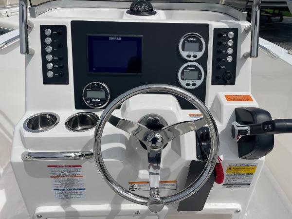 Slide: The Image of 2023 Robalo R180 Center Console dashboard with steering wheel and controls. - 24
