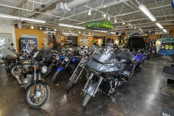 Slide: The Image of Motorcycle showroom with various models displayed under bright lighting. - 48