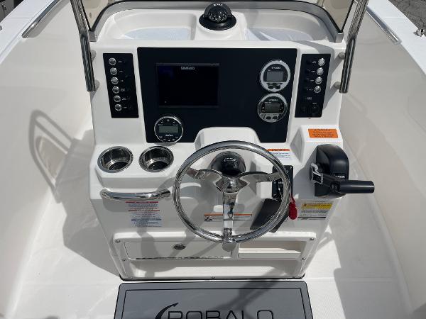 Slide: The Image of 2023 Robalo R180 Center Console boat dashboard with steering wheel and controls. - 5