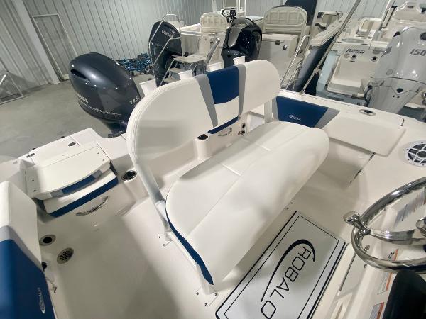 Slide: The Image of 2024 Robalo R180 Center Console boat interior with seating and outboard motor. - 7