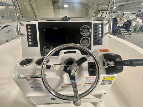Slide: The Image of 2024 Robalo R180 Center Console boat dashboard with steering wheel and control panel. - 9