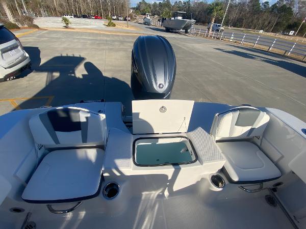 Slide: The Image of 2024 Robalo R200 Center Console boat interior with seating and engine. - 8