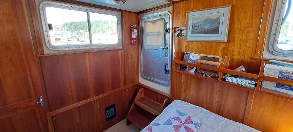 Slide: The Image of Interior cabin of 1999 Rozema Boat Works Custom 42 with wooden paneling and bed. - 22