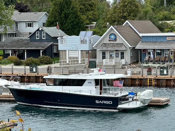 Slide: The Image of Sargo 45 boat docked near waterfront buildings, 2023 model. - 34