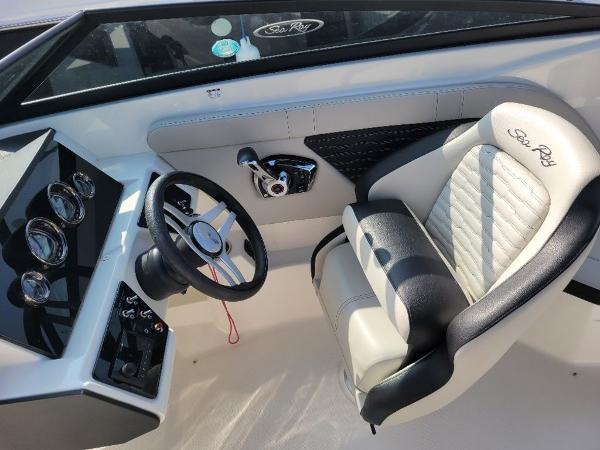Slide: The Image of 2023 Sea Ray 230 SPX boat interior, steering wheel, and captain's seat. - 9