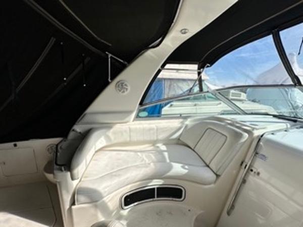 Slide: The Image of 1998 Sea Ray 290 Sundancer interior seating area with black canopy. - 12