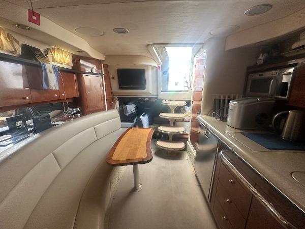 Slide: The Image of Interior of 2006 Sea Ray 340 Sundancer yacht with kitchen and seating area. - 43