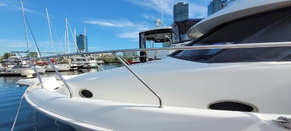 Slide: The Image of 2000 Silverton 392 Motor Yacht docked at a marina with city skyline. - 10