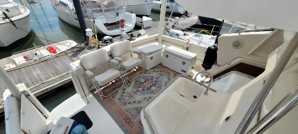 Slide: The Image of 2000 Silverton 392 Motor Yacht deck with seating and storage at marina. - 14