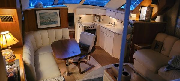 Slide: The Image of Interior of a 2000 Silverton 392 Motor Yacht with kitchen and dining area. - 16