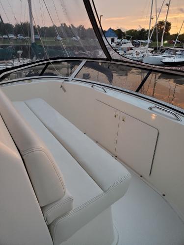 Slide: The Image of 2000 Silverton 392 Motor Yacht interior with white seating at sunset. - 19