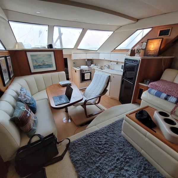 Slide: The Image of Interior of a 2000 Silverton 392 Motor Yacht with modern furnishings and kitchen. - 23