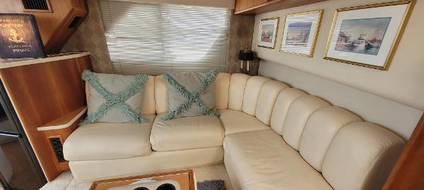Slide: The Image of Luxurious interior of a 2000 Silverton 392 Motor Yacht with cream leather sofa and decorative pillows. - 35
