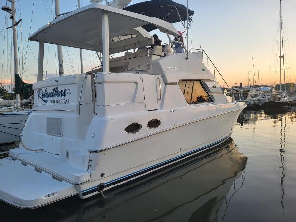 Slide: The Image of 2000 Silverton 392 Motor Yacht docked at sunset. - 37