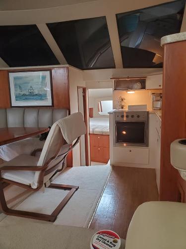 Slide: The Image of Interior of 2000 Silverton 392 Motor Yacht with dining area and kitchen. - 38