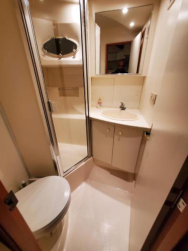 Slide: The Image of 2000 Silverton 392 Motor Yacht bathroom with shower, sink, and toilet. - 39
