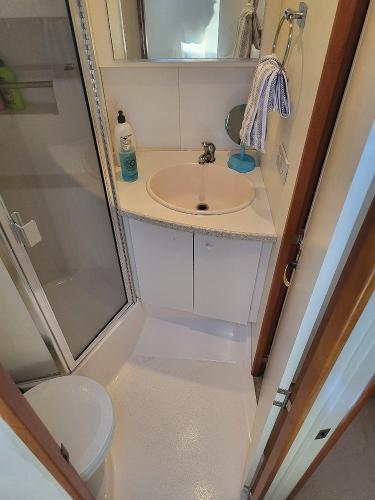 Slide: The Image of Bathroom in a 2000 Silverton 392 Motor Yacht with sink, shower, and toilet. - 42